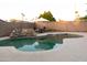 Backyard with an in-ground swimming pool, rock waterfall feature, and outdoor seating area at 1894 E Julie Dr, Tempe, AZ 85283
