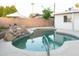 Inviting swimming pool with rock waterfall feature and privacy wall at 1894 E Julie Dr, Tempe, AZ 85283