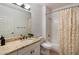 Cozy bathroom featuring granite countertop, white cabinets, and shower with decorative curtains at 20801 N 90Th Pl # 157, Scottsdale, AZ 85255