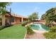 Beautiful backyard showcasing a large pool, lush landscaping, and spiral staircase at 2229 S 82Nd Ln, Phoenix, AZ 85043