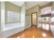 Bright bathroom featuring a soaking tub, glass block window, and shower stall at 2229 S 82Nd Ln, Phoenix, AZ 85043