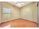 Empty bedroom featuring stained concrete floors and ample natural light from a large window at 2229 S 82Nd Ln, Phoenix, AZ 85043