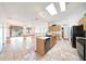 Open kitchen design with breakfast bar and views into the dining and living areas at 2229 S 82Nd Ln, Phoenix, AZ 85043