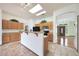 Kitchen with island, wood cabinets and views to front entry at 2229 S 82Nd Ln, Phoenix, AZ 85043