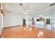 Bright open-concept living area featuring stained concrete floors and a view into the kitchen at 2229 S 82Nd Ln, Phoenix, AZ 85043