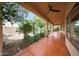 Long covered patio with ceiling fans overlooking the backyard pool and landscaping at 2229 S 82Nd Ln, Phoenix, AZ 85043