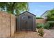The backyard has a large storage shed on a rock bed and enclosed by a privacy wall at 2229 S 82Nd Ln, Phoenix, AZ 85043