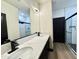 Elegant bathroom featuring a dual sink vanity with quartz countertops and a glass-enclosed shower at 22504 W Meade Ln, Buckeye, AZ 85326