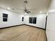 Spacious bedroom with vinyl flooring, a ceiling fan, and natural light from the large window at 22504 W Meade Ln, Buckeye, AZ 85326