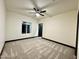 Bright bedroom featuring carpet, a modern ceiling fan, and a walk-in closet at 22504 W Meade Ln, Buckeye, AZ 85326