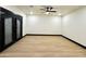 Spacious living room with wood-look floors, a ceiling fan, and modern trim at 22504 W Meade Ln, Buckeye, AZ 85326
