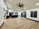 Open concept living space with wood flooring, recessed lighting, and a large sliding glass door to the outside at 22504 W Meade Ln, Buckeye, AZ 85326