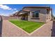 A backyard showcasing a covered patio, a well-manicured lawn, and secure fencing at 22660 N 122Nd Ave, Sun City, AZ 85373