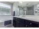 Bathroom vanity includes a soaking tub, single sink and dark cabinets at 22660 N 122Nd Ave, Sun City, AZ 85373