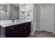 Bathroom vanity includes a single sink, white countertops and dark cabinets at 22660 N 122Nd Ave, Sun City, AZ 85373