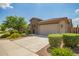 Well-maintained home with desert landscaping, a wide driveway, and an attached two-car garage at 22660 N 122Nd Ave, Sun City, AZ 85373