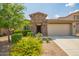 Charming home featuring a stone facade, tile roof, and meticulously landscaped front yard at 22660 N 122Nd Ave, Sun City, AZ 85373