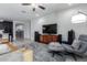 Comfortable living room featuring a large TV and sleek furniture at 22660 N 122Nd Ave, Sun City, AZ 85373