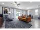Spacious living room with a ceiling fan and sliding doors leading to the backyard at 22660 N 122Nd Ave, Sun City, AZ 85373