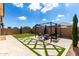 Lush backyard featuring manicured lawn, patio with seating, and privacy fence at 2716 S Chatsworth --, Mesa, AZ 85209