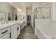 Bathroom with a double vanity, soaking tub, glass enclosed shower and large walk-in closet at 2716 S Chatsworth --, Mesa, AZ 85209