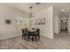 Neutral dining room with black wooden table, pendant lighting and rustic wood-look tile floor at 2716 S Chatsworth --, Mesa, AZ 85209