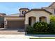 Inviting home featuring an attached garage, tile roof, and vibrant landscaping at 2716 S Chatsworth --, Mesa, AZ 85209
