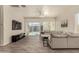 Bright living room featuring tile flooring, large sectional, and sliding glass doors at 2716 S Chatsworth --, Mesa, AZ 85209