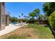 Expansive backyard featuring a pool, lush greenery, and a cozy seating area, perfect for outdoor relaxation at 3089 E Indigo Bay Dr, Gilbert, AZ 85234