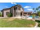 A spacious backyard features a pool, patio, lush lawn, and outdoor seating, ideal for relaxing and entertaining at 3089 E Indigo Bay Dr, Gilbert, AZ 85234