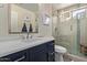 Clean bathroom with a walk-in shower, single sink vanity and contemporary fixtures at 3089 E Indigo Bay Dr, Gilbert, AZ 85234