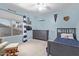 Charming bedroom with blue walls, baseball decor, and a ceiling fan at 3089 E Indigo Bay Dr, Gilbert, AZ 85234