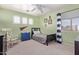 Bright bedroom featuring carpet floors, ceiling fan, and a window offering natural light at 3089 E Indigo Bay Dr, Gilbert, AZ 85234