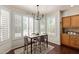Cozy breakfast nook with lots of natural light, modern lighting and table for four at 3089 E Indigo Bay Dr, Gilbert, AZ 85234