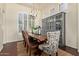 Charming dining room featuring a wooden table, decorative lighting, and large windows at 3089 E Indigo Bay Dr, Gilbert, AZ 85234