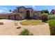 Charming two-story home with a well-manicured lawn and a three-car garage, showcasing excellent curb appeal at 3089 E Indigo Bay Dr, Gilbert, AZ 85234