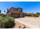 Two-story home with desert landscaping, a spacious three-car garage, and a well-maintained lawn at 3089 E Indigo Bay Dr, Gilbert, AZ 85234