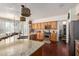 Well-lit kitchen with wood cabinetry, stainless steel appliances, and island featuring granite countertops at 3089 E Indigo Bay Dr, Gilbert, AZ 85234