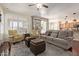 Open-concept living room featuring hardwood floors, plantation shutters, and access to the backyard at 3089 E Indigo Bay Dr, Gilbert, AZ 85234