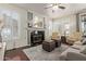 Inviting living room with a cozy fireplace, plantation shutters, and stylish furniture at 3089 E Indigo Bay Dr, Gilbert, AZ 85234