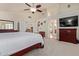 Well-lit main bedroom with neutral carpeting, ceiling fan, and access to other rooms at 3089 E Indigo Bay Dr, Gilbert, AZ 85234
