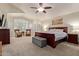 Spacious main bedroom with a ceiling fan, sitting area, and large windows at 3089 E Indigo Bay Dr, Gilbert, AZ 85234