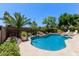 Sparkling pool with a waterfall feature, lush landscaping, and plenty of room to relax at 3089 E Indigo Bay Dr, Gilbert, AZ 85234