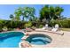 Beautiful pool area with a spa, lounge chairs, and lush landscaping at 3089 E Indigo Bay Dr, Gilbert, AZ 85234