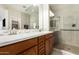 Modern bathroom with double sinks, wood cabinets, and a spacious glass shower at 31219 N 6Th Pl, Phoenix, AZ 85085