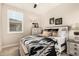 Bedroom with a ceiling fan and neutral walls with a queen-sized bed and a window with plantation shutters at 31219 N 6Th Pl, Phoenix, AZ 85085