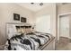 Bedroom featuring neutral walls and a queen-sized bed with decorative pillows and white closet doors at 31219 N 6Th Pl, Phoenix, AZ 85085