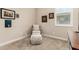 Cozy bedroom showcasing a comfortable armchair, ottoman, and a window with plantation shutters at 31219 N 6Th Pl, Phoenix, AZ 85085