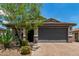 Charming single-story home with a two-car garage, desert landscaping, and a brick paver driveway at 31219 N 6Th Pl, Phoenix, AZ 85085