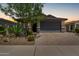 Charming single-story home with a two-car garage, desert landscaping, and a brick paver driveway at 31219 N 6Th Pl, Phoenix, AZ 85085